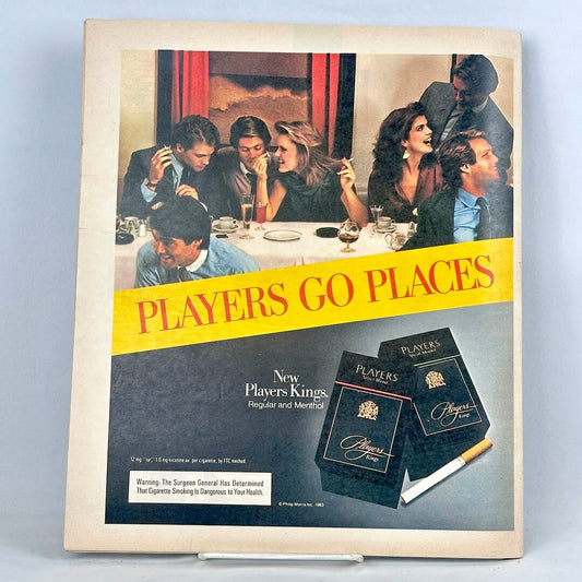 Back cover of magazine with full page ad for Players Kings cigarettes featuring image of dinner party. 