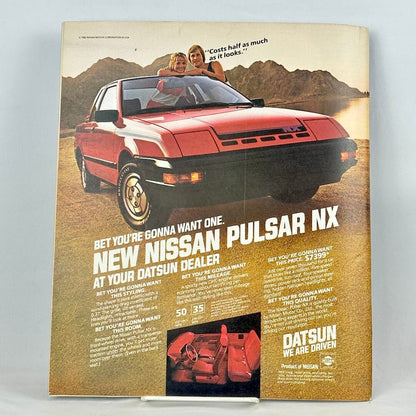 Back cover of magazine with full page ad for a Datsun vehicle set on a beach. 