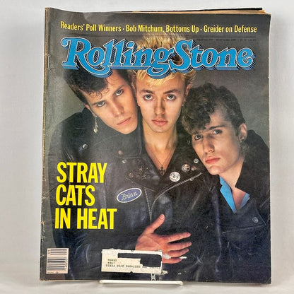 A vintage Rolling Stone magazine cover featuring the musical group, the Stray Cats in leather jackets. 