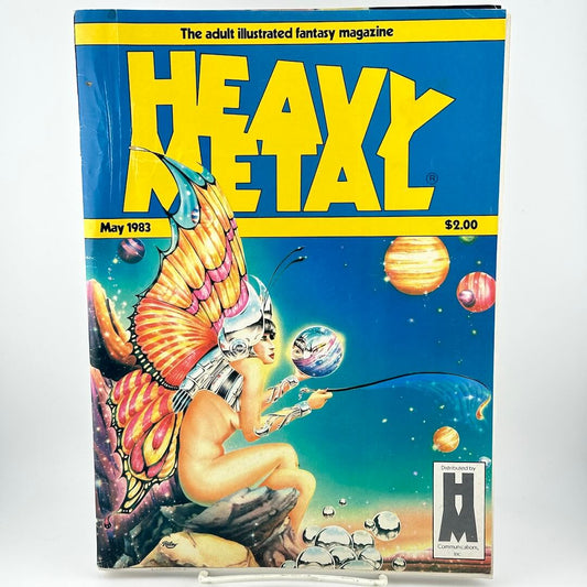 "Heavy Metal" magazine cover with fairy-like woman on ledge playing with planets like balls. 