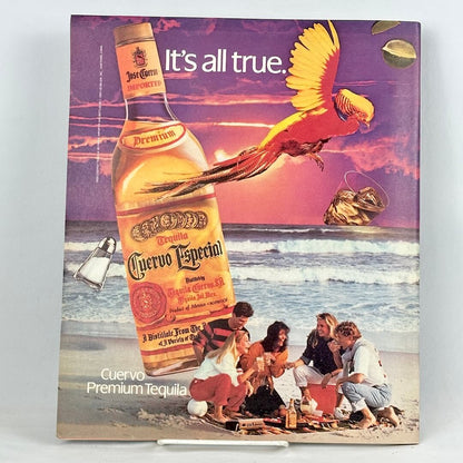 Back cover of magazine with full page ad for Cuervo tequila featuring a beach party scene. 