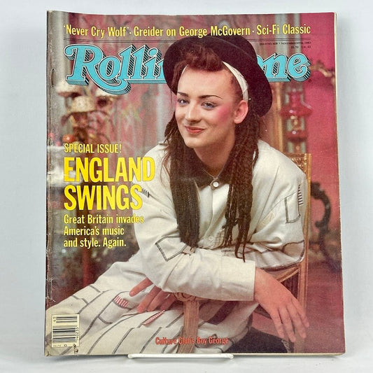 Vintage issue of Rolling Stone magazine with seated Boy George smiling at camera on cover. 