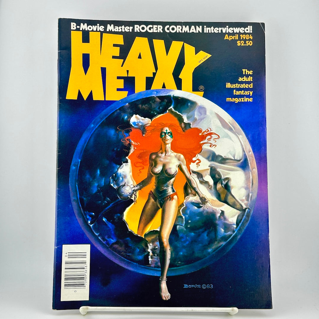 Vintage Heavy Metal magazine cover featuring illustration of futuristic woman emerging from sphere. 