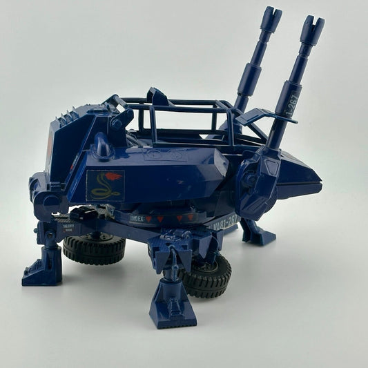 Blue tactical vehicle with four legs, two wheels, roll cage, twin cannons at front, & tow hitch, with red & white Cobra decals.