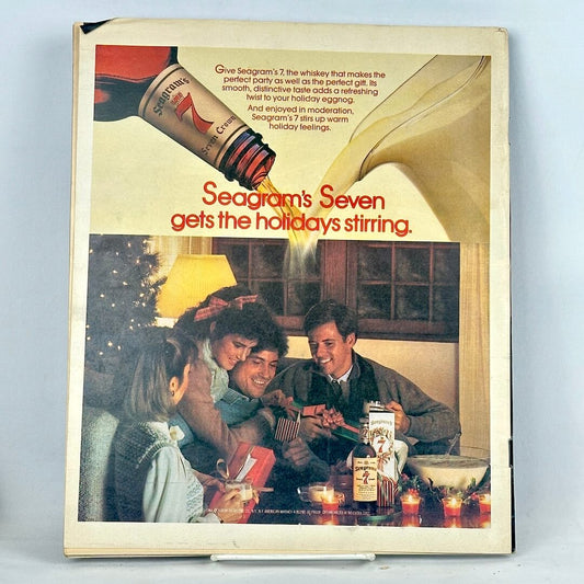 Back cover of magazine with full page ad for Seagram's 7 with image of holiday party below pouring liquor. 