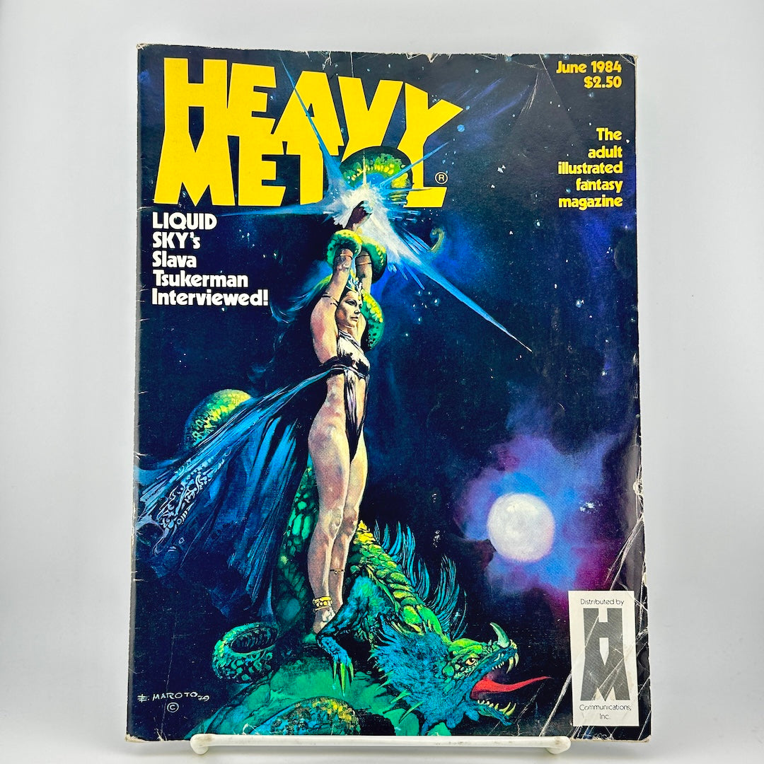 Vintage Heavy Metal magazine cover featuring illustration of woman and dragon set against starry background. 