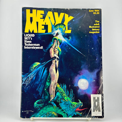 Vintage Heavy Metal magazine cover featuring illustration of woman and dragon set against starry background. 