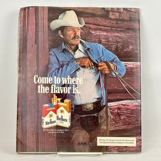 Back cover of magazine with full page ad for Marlboro cigarettes featuring image of smoking cowboy. 