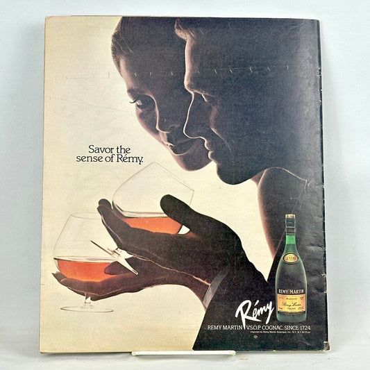 Back cover of magazine with full page ad for Remy Martin cognac with two silhouettes holding glasses. 