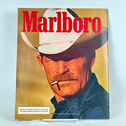 Back cover of magazine with full page ad for Marlboro cigarettes featuring up close portrait of smoking cowboy.