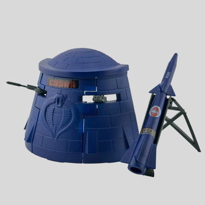 Navy blue bunker with two grey machine guns, separate navy rocket with rey stand, all with red Cobra stickers. 