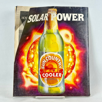 Back cover of magazine with top corner creased, and an ad for Sun Country Coolers featuring image of bottle. 