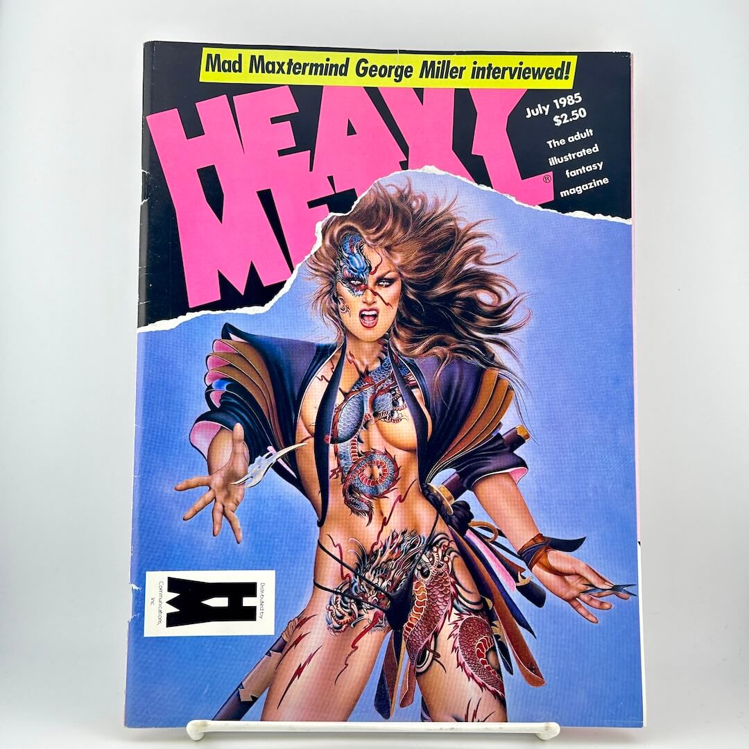 Vintage Heavy Metal magazine with bold cover illustration of a tattooed female figure on a blue background. 
