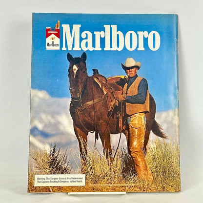 Back cover of magazine with full page ad for Marlboro cigarettes featuring image of smoking cowboy by horse. 