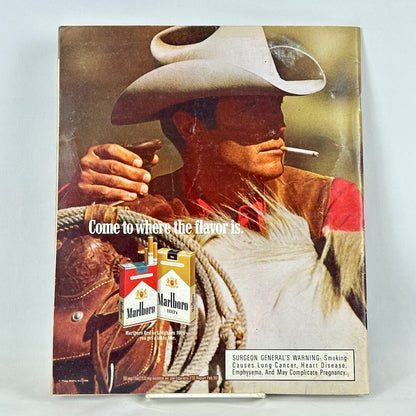 Back cover of magazine with full page ad for Marlboro cigarettes featuring image of smoking cowboy. 