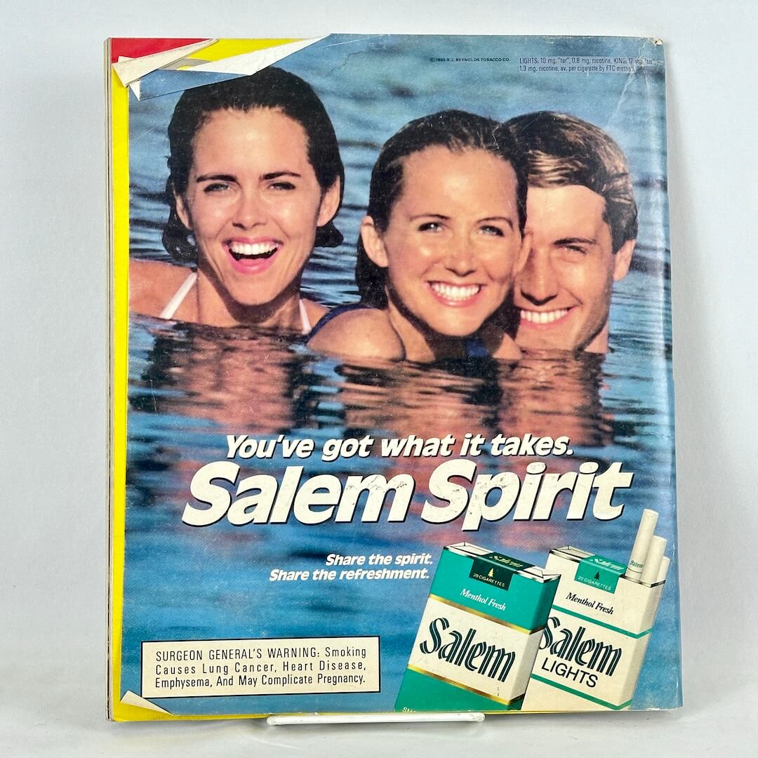 Back cover of magazine with full page ad for Salem cigarettes featuring three people in body of water smiling at camera. 