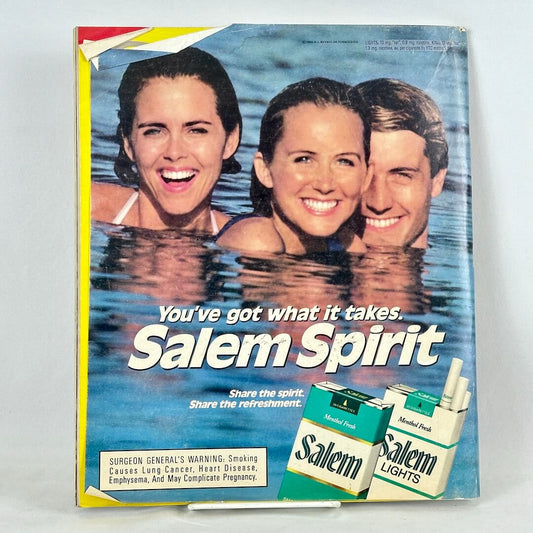 Back cover of magazine with full page ad for Salem cigarettes featuring three people in body of water smiling at camera. 