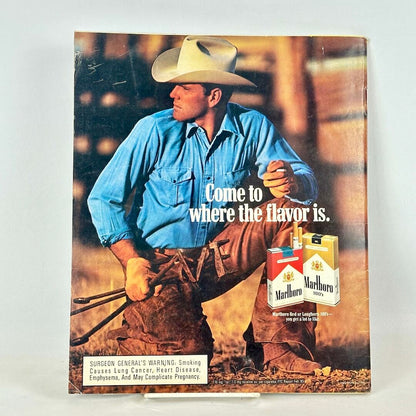 Back cover of magazine with full page ad for Marlboro cigarettes featuring image of crouching cowboy.