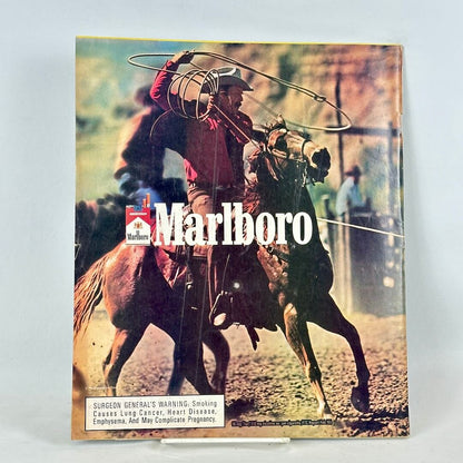 Back cover of magazine with full page ad for Marlboro cigarettes featuring roping cowboy on horseback. 