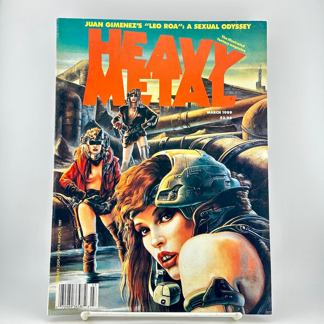 Heavy Metal magazine with illustrated cover art with two women in futuristic armor and a large orange title.