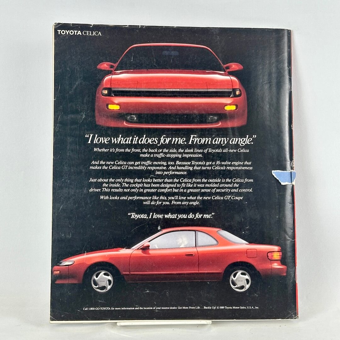 Back cover of magazine with full page ad for Toyota Celica featuring and front and side view of red vehicle. 