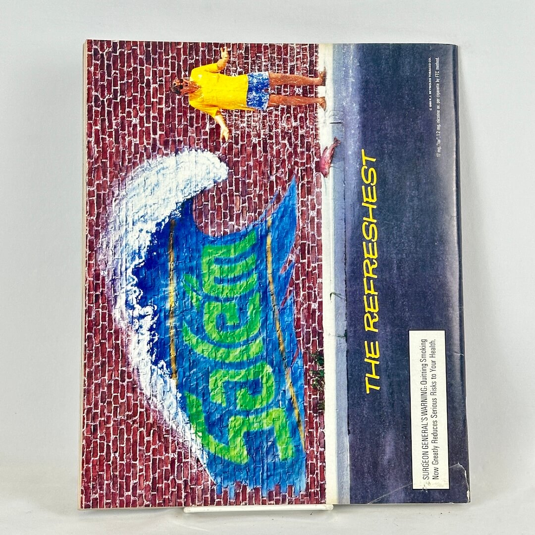 Back cover of magazine with full page ad for Salem cigarettes featuring image of graffitied wall with wave. 