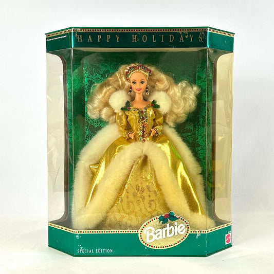 Barbie doll in a yellow dress with fur trim in a 'Happy Holidays' themed box.