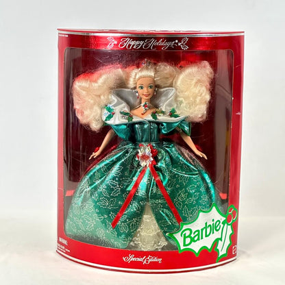 Barbie doll in a green dress with red accents in a Happy Holidays packaging.