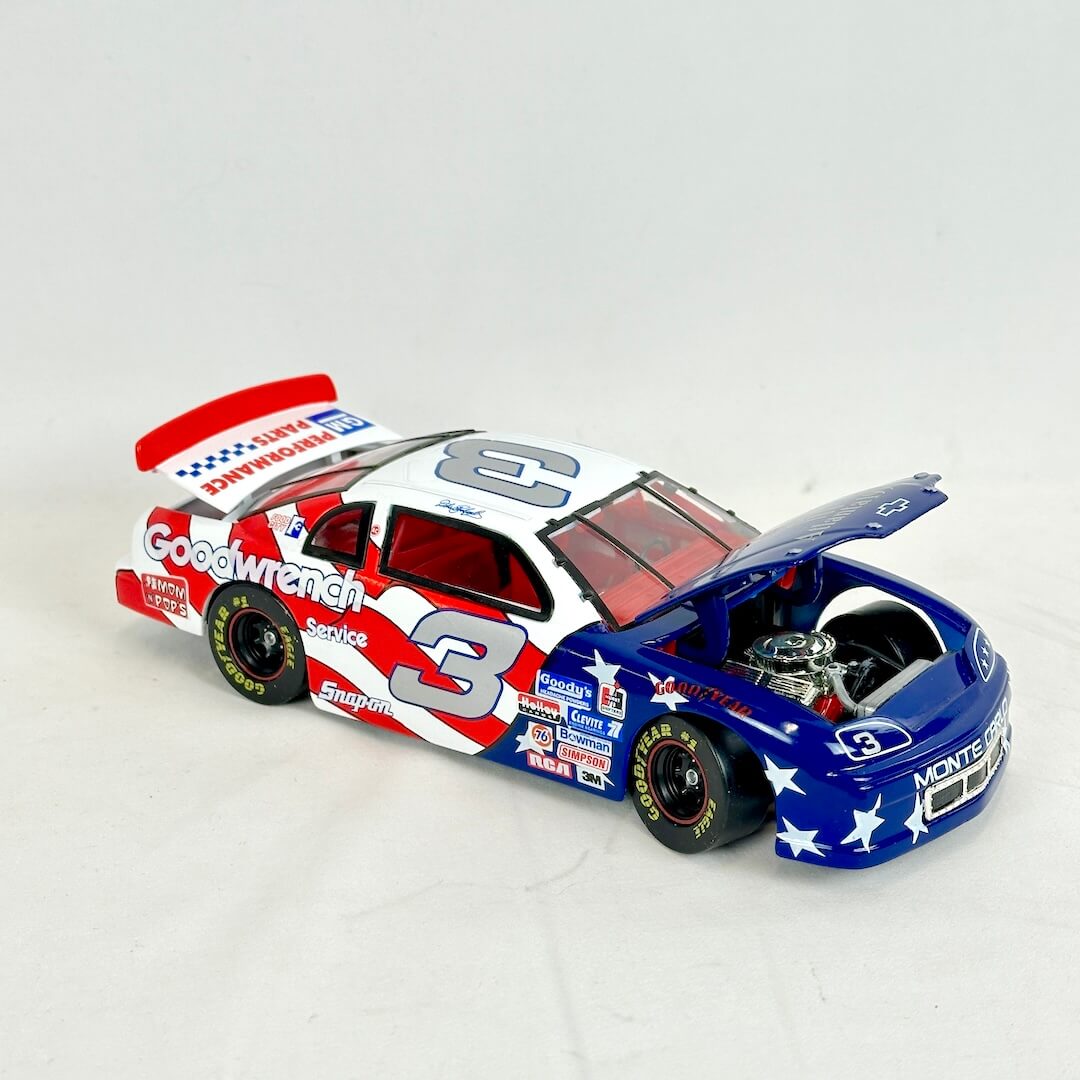 Model race car with open hood on a white background