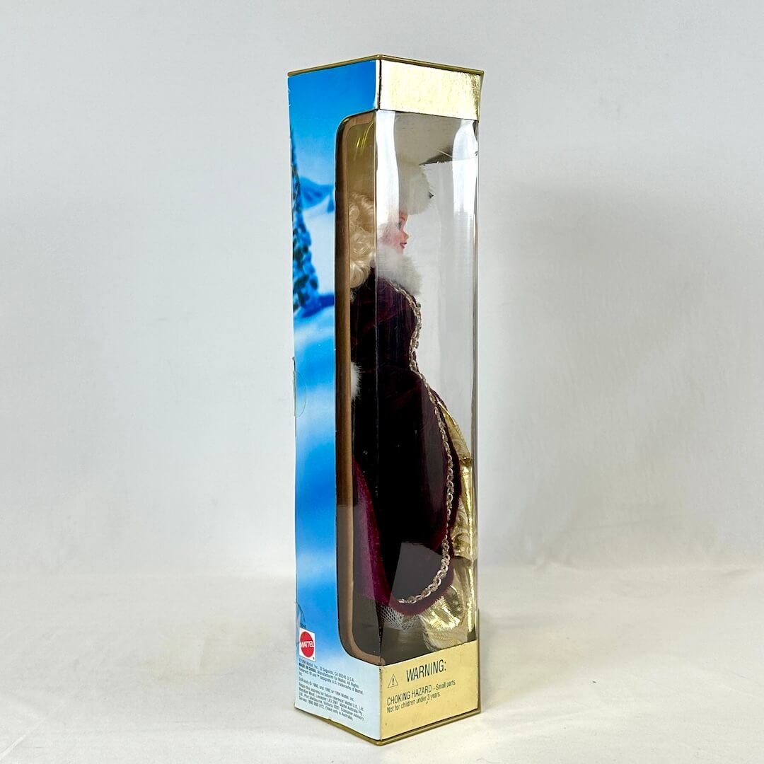 Product packaging with a clear window showing a doll inside on a white background