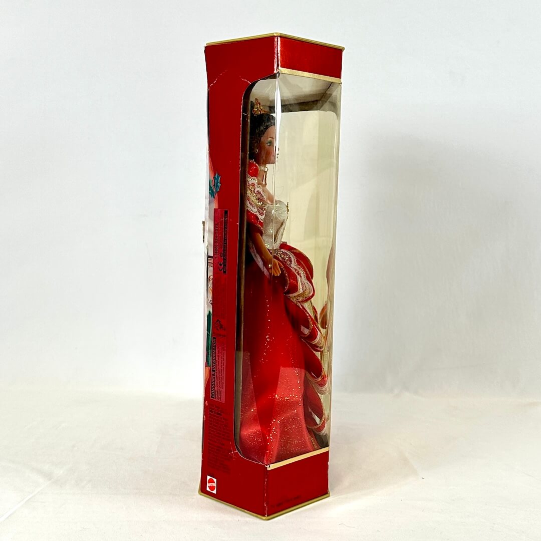 Doll in a red box with a clear front on a white background