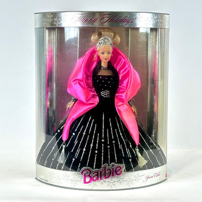 Barbie doll in a black dress with pink shawl in a 'Happy Holidays' packaging.