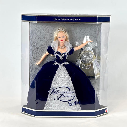Barbie doll in a navy blue and white gown with a tiara, displayed in a clear box.