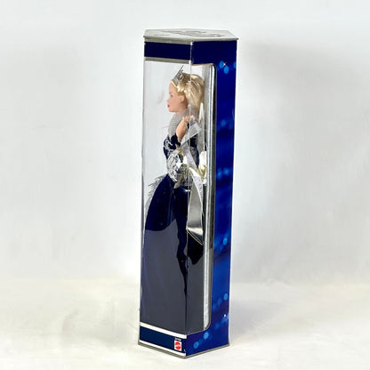 Doll in a blue and silver box on a white background