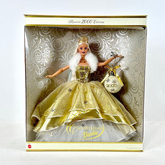 Barbie doll in a gold dress with a white fur boa in a decorative box.