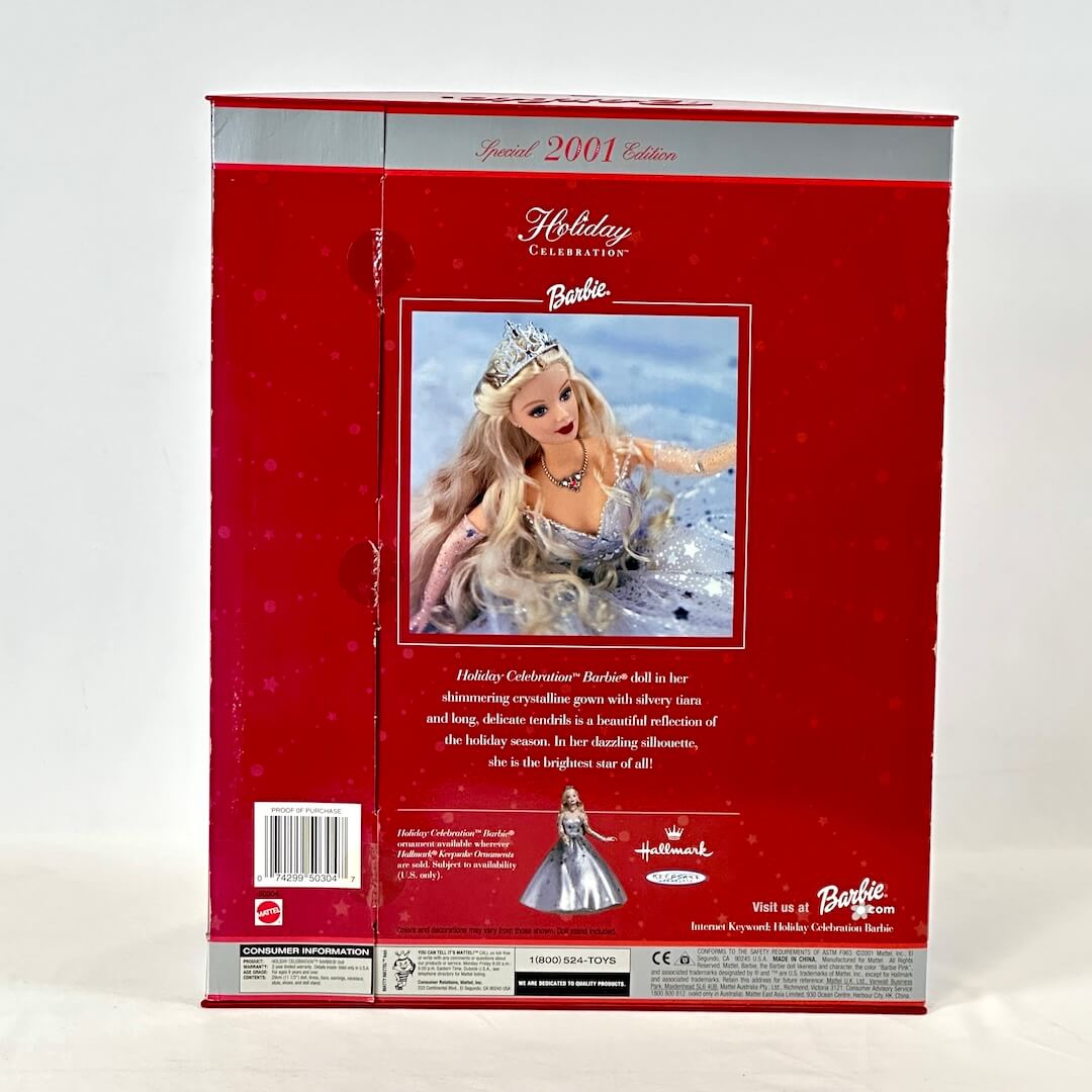 Barbie Holiday Celebration doll packaging with a red background
