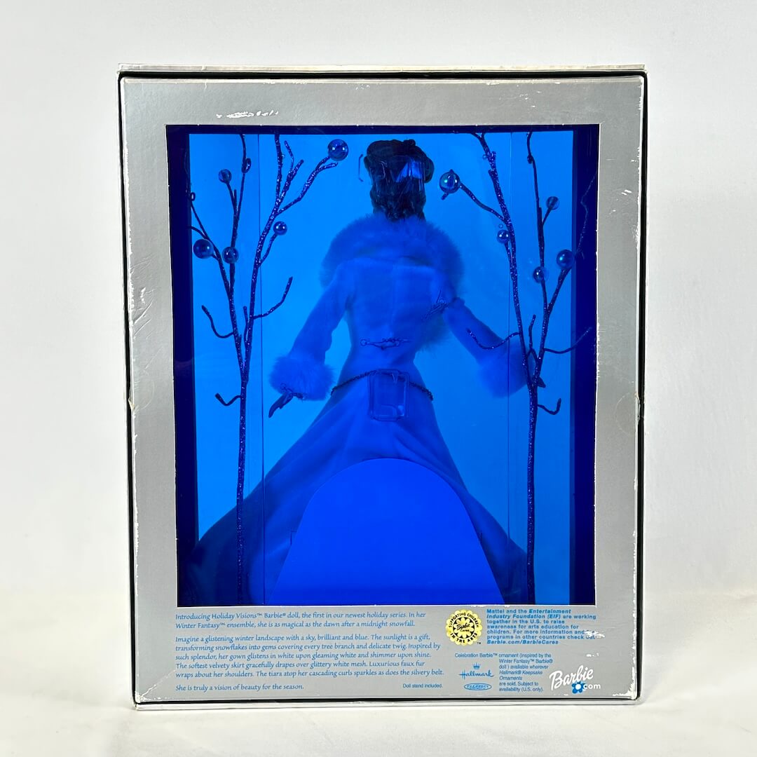 Backside of Barbie packaging, silver box with blue transparent back. 