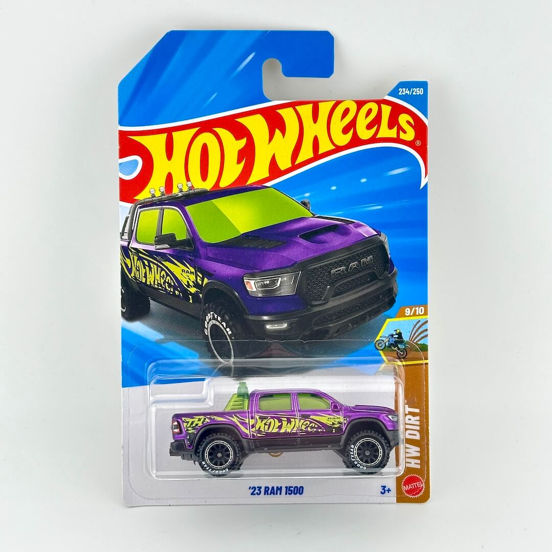 Hot Wheels '23 RAM 1500 in original blister packaging, showing a purple truck and Hot Wheels logo. 