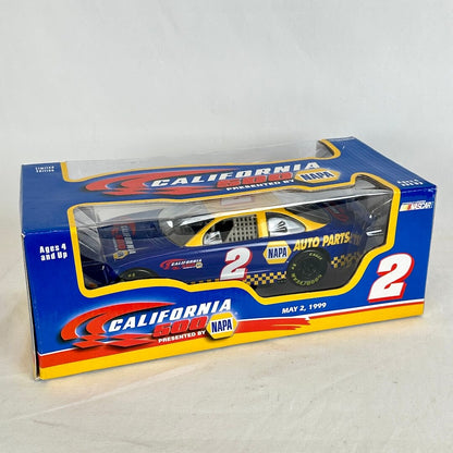 A boxed diecast model race car displayed in its retail packaging. The car is blue with yellow and white graphics.