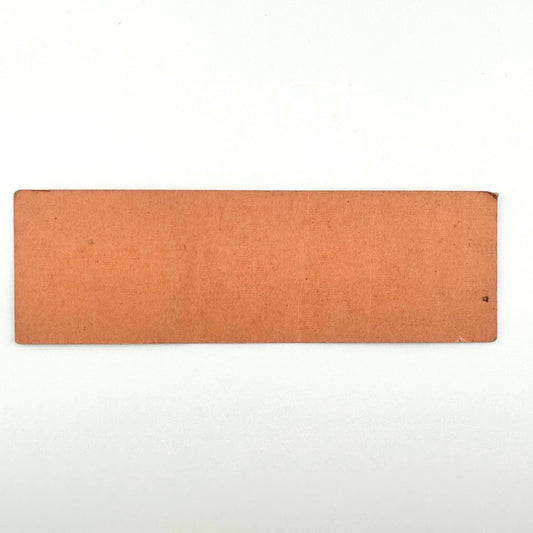 Backside of orange rectangular ticket with some ink transfer and a small amount of dirt, one rolled corner, no other wear.