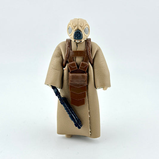 Action figure in a beige costume with a helmet and weapon on a white background