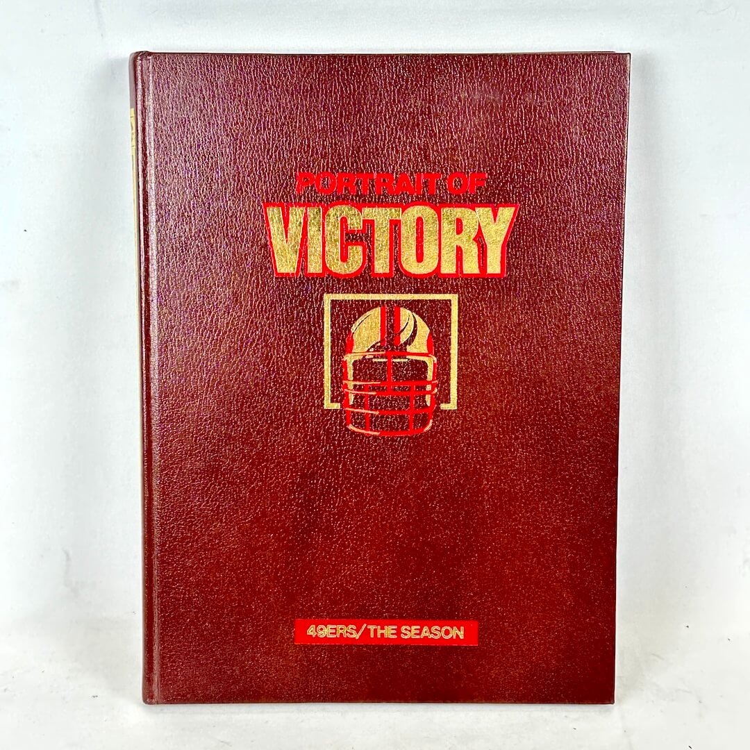 Red book titled 'Portrait of Victory' on a white background