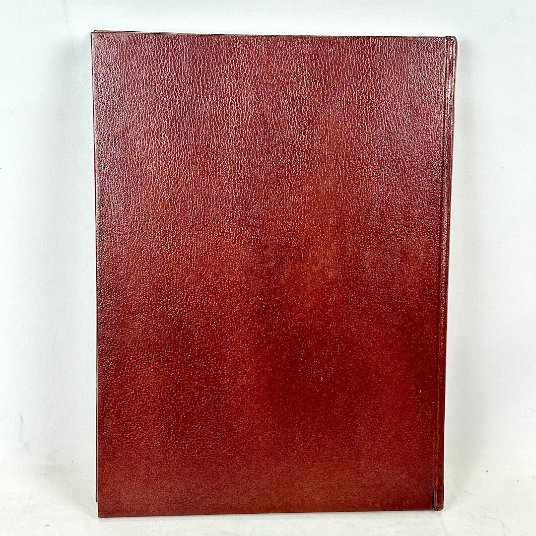 Red leather-bound book on a white background