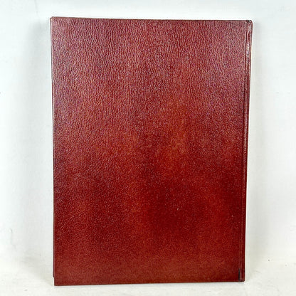 Red leather-bound book on a white background