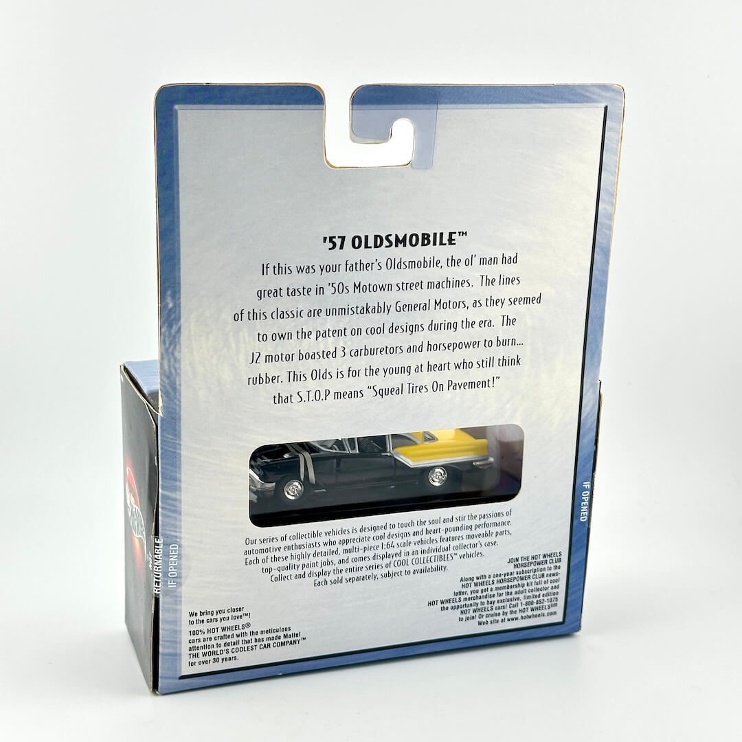 Back view of a packaged toy car set in its retail box, showing printed product information and a small window.