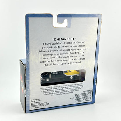 Back view of a packaged toy car set in its retail box, showing printed product information and a small window.
