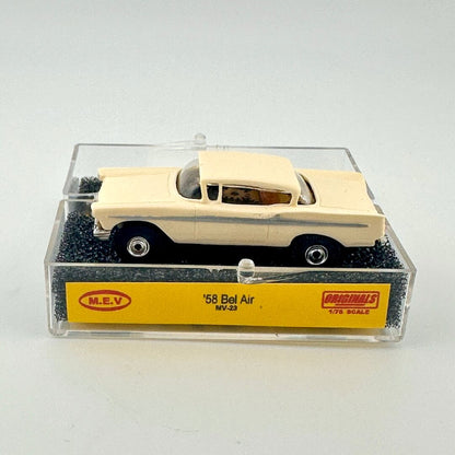 Model car of a '58 Bel Air in a clear display case with a yellow label on a white background