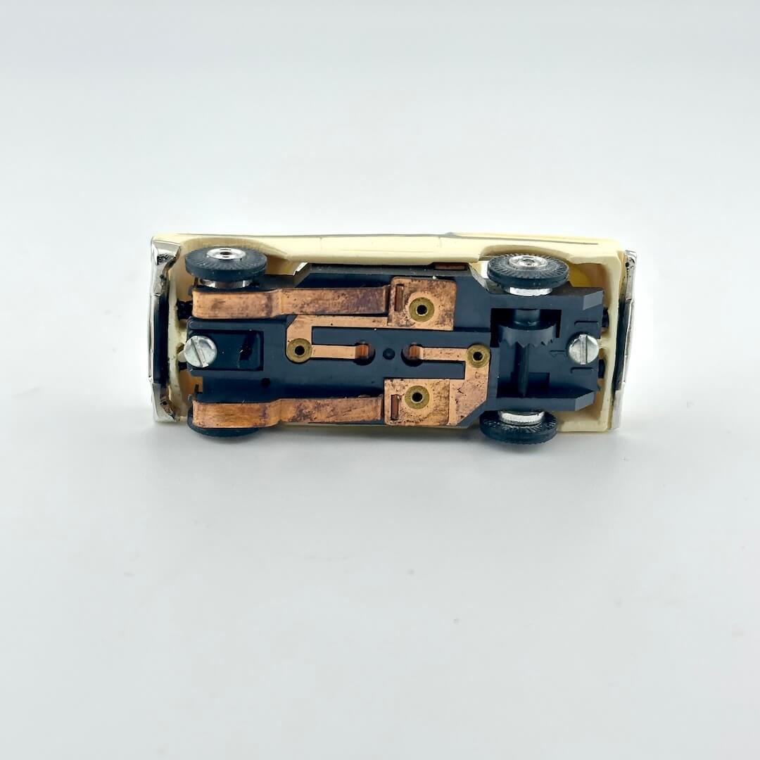 Underside of slot car on a white background