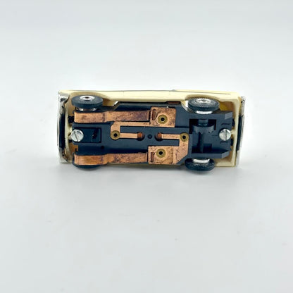 Underside of slot car on a white background