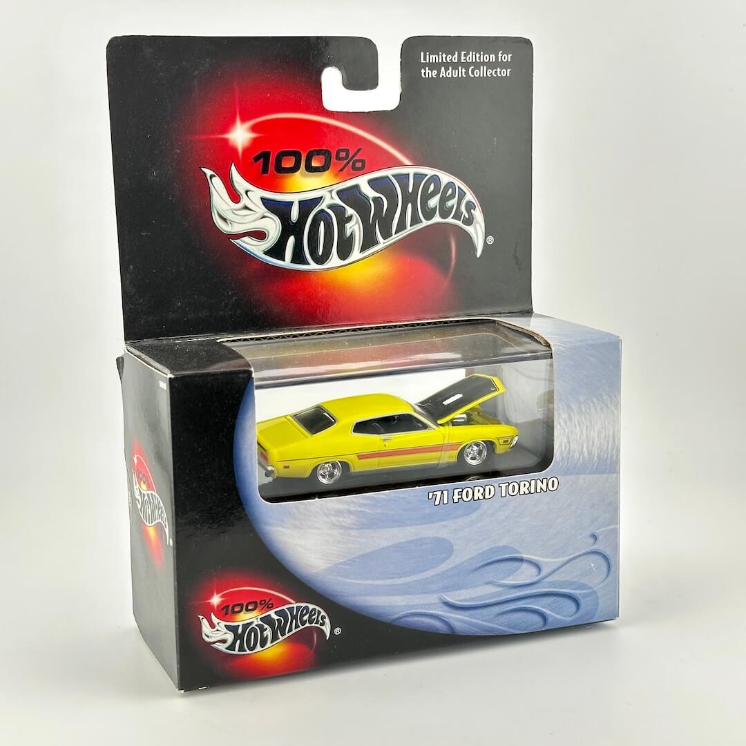 Hot Wheels '71 Ford Torino die-cast toy car in its original packaging, featuring a yellow car with a black hood.